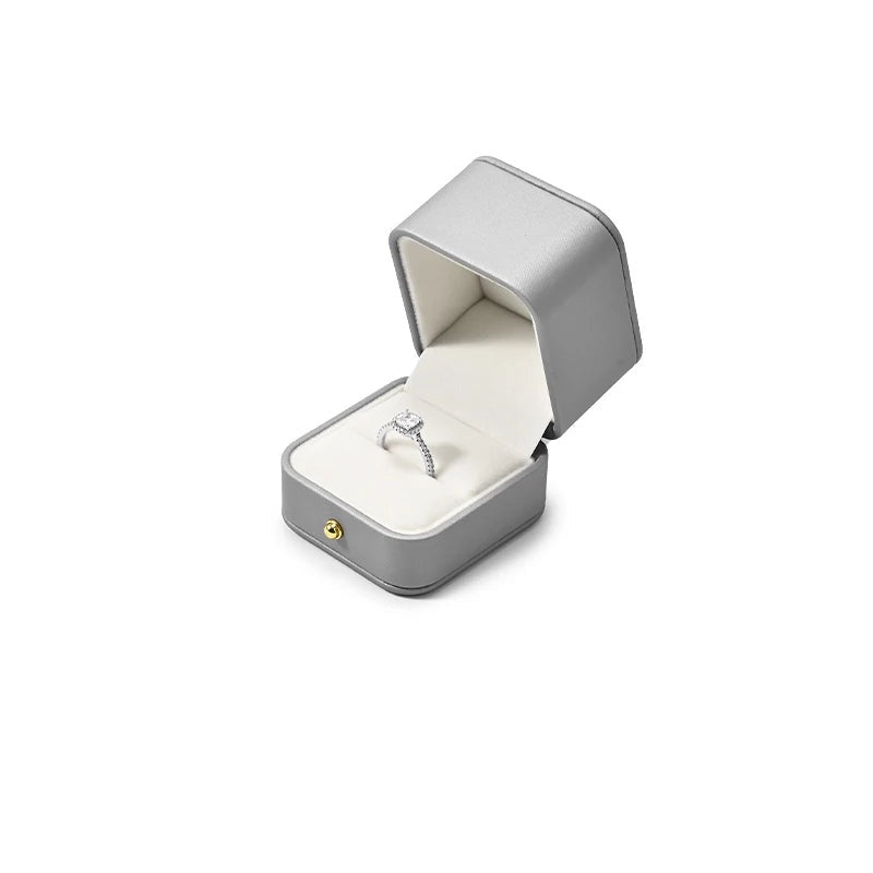 Écrin gris – écrin à bague ouvert avec une bague